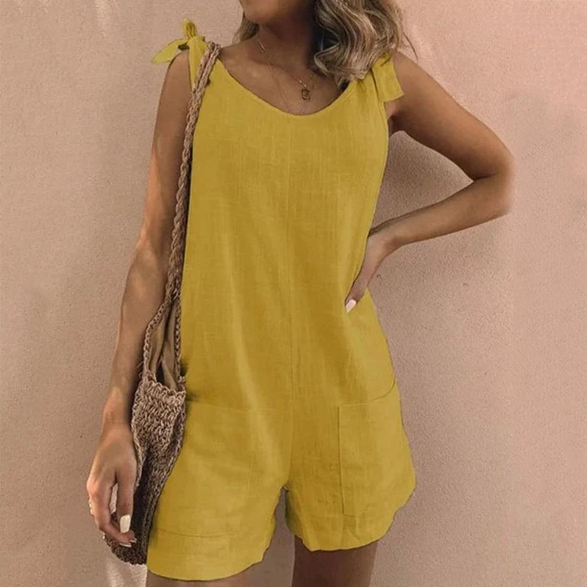 Relaxed fit playsuit with bow straps and pockets.