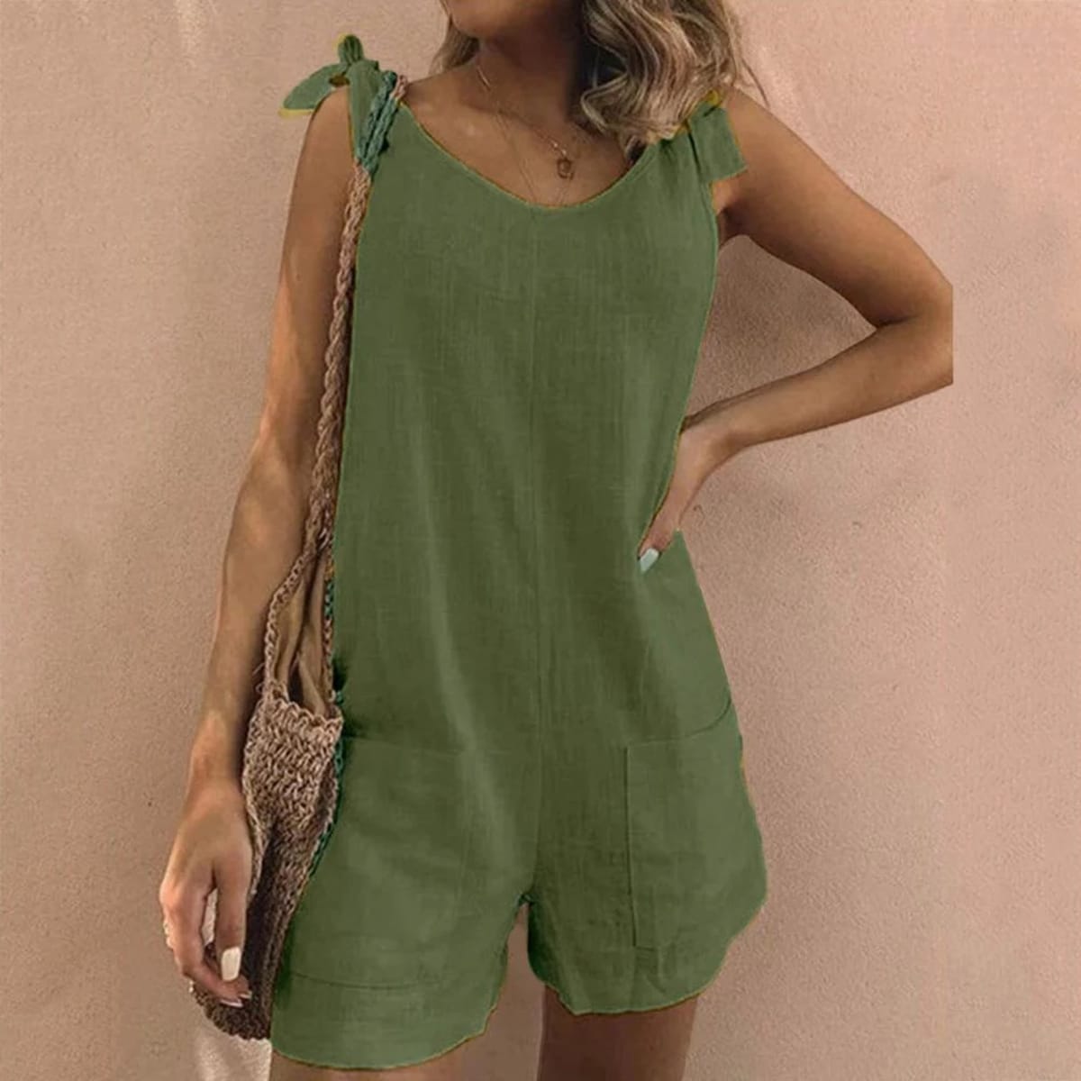 Relaxed fit playsuit with bow straps and pockets.