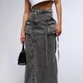 Maxi denim skirt with asymmetric waist, cargo pockets, decorative straps.