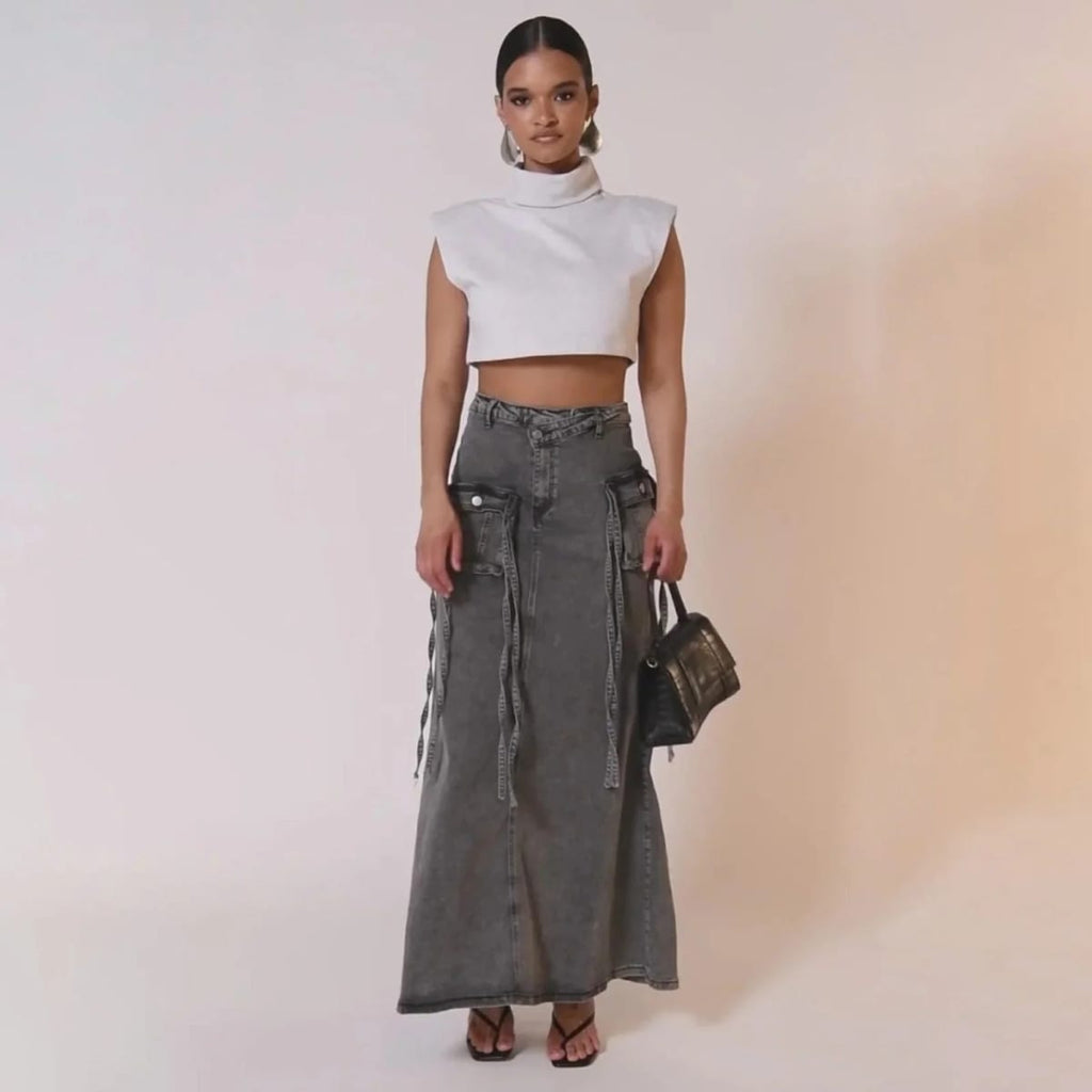 Maxi denim skirt with asymmetric waist, cargo pockets, decorative straps.