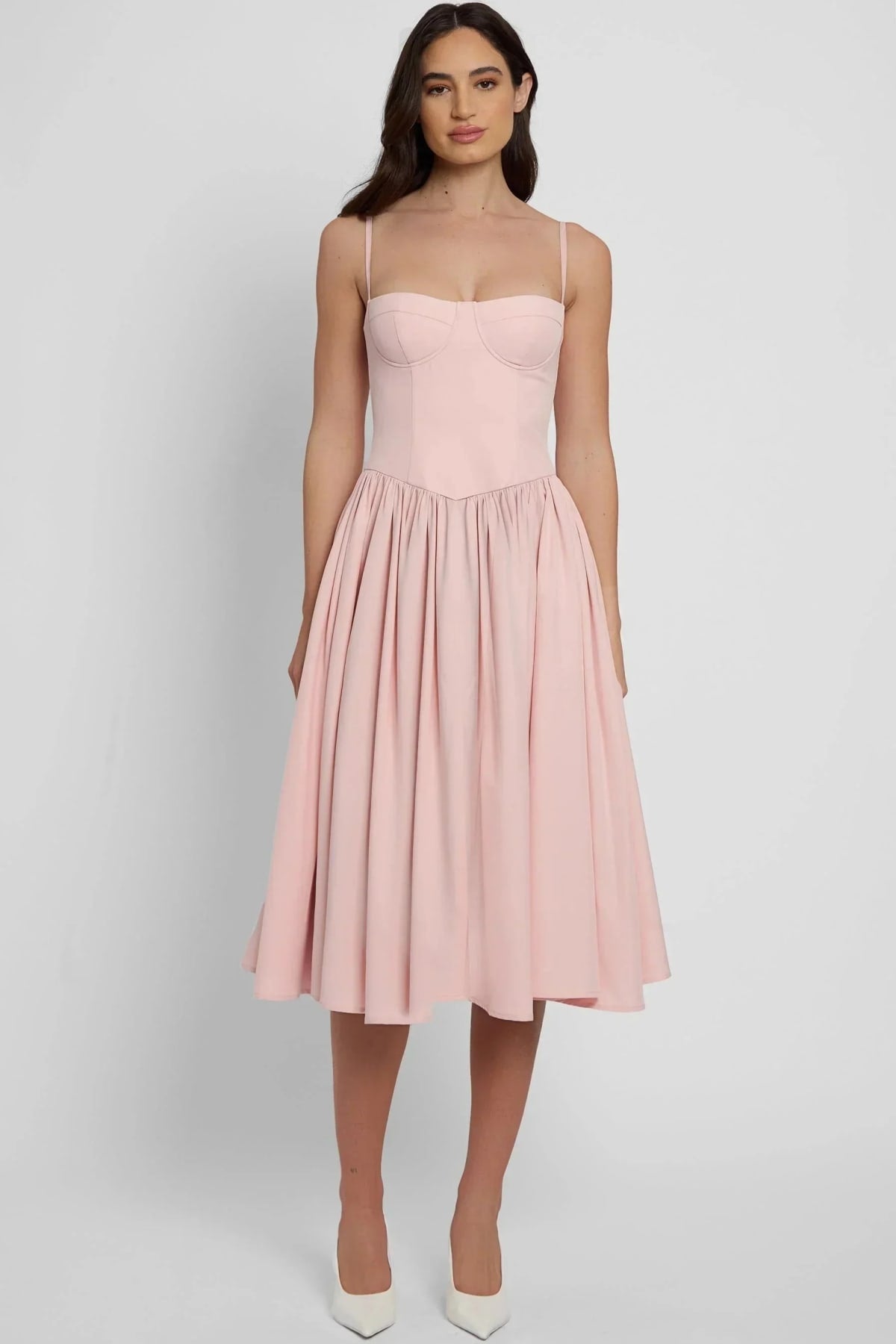 Woman wearing a bustier A-line midi dress with spaghetti straps.