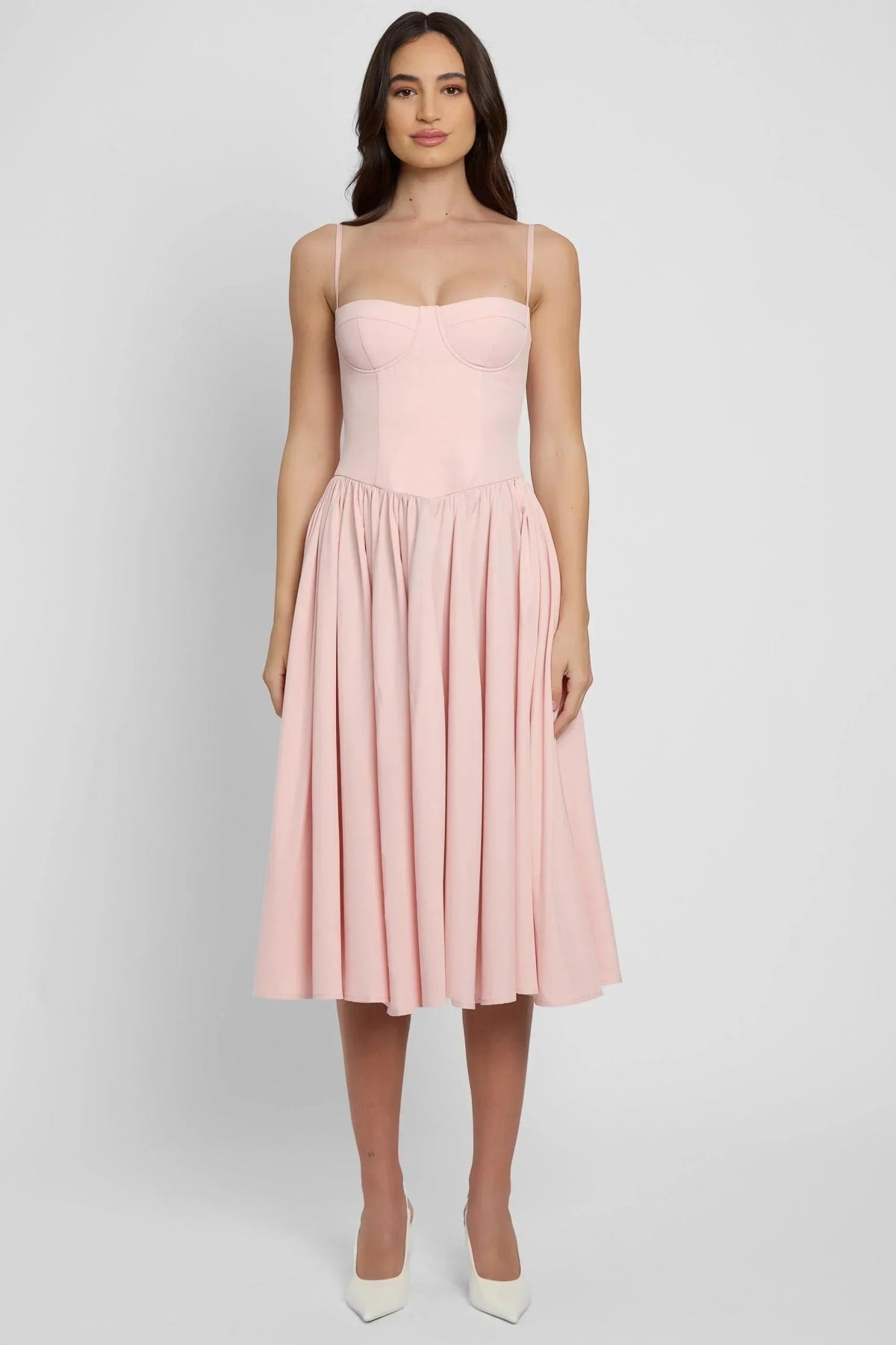 Woman wearing a bustier A-line midi dress with spaghetti straps.
