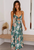 Woman in floral cutout midi dress with spaghetti straps.
