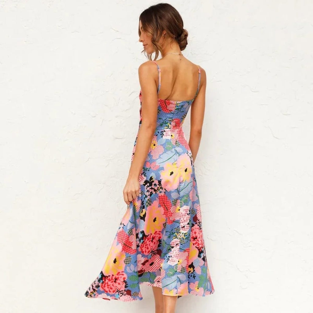 Woman in floral cutout midi dress with spaghetti straps.