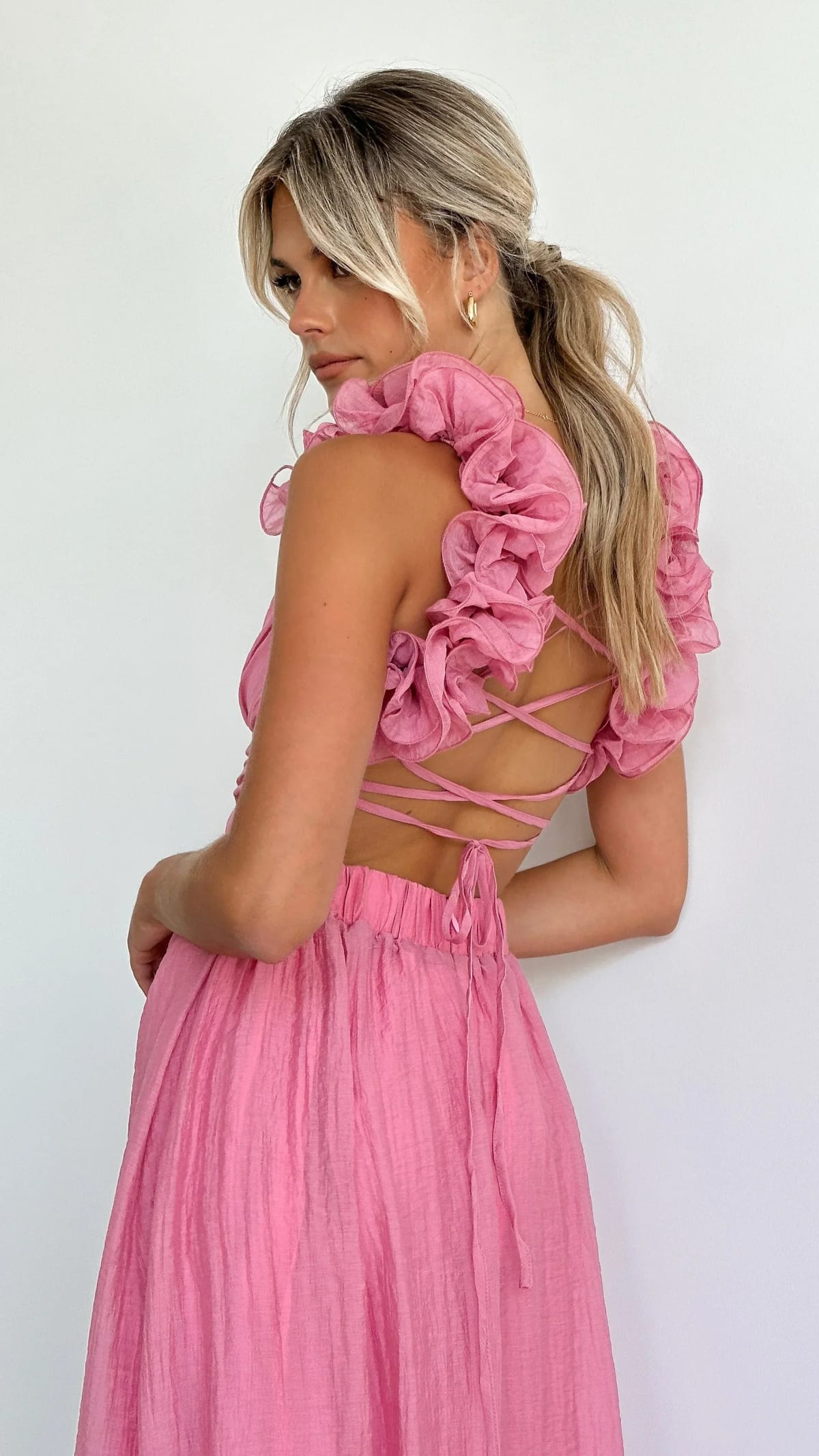 Woman wearing a midi dress with V-neck and floral shoulders.