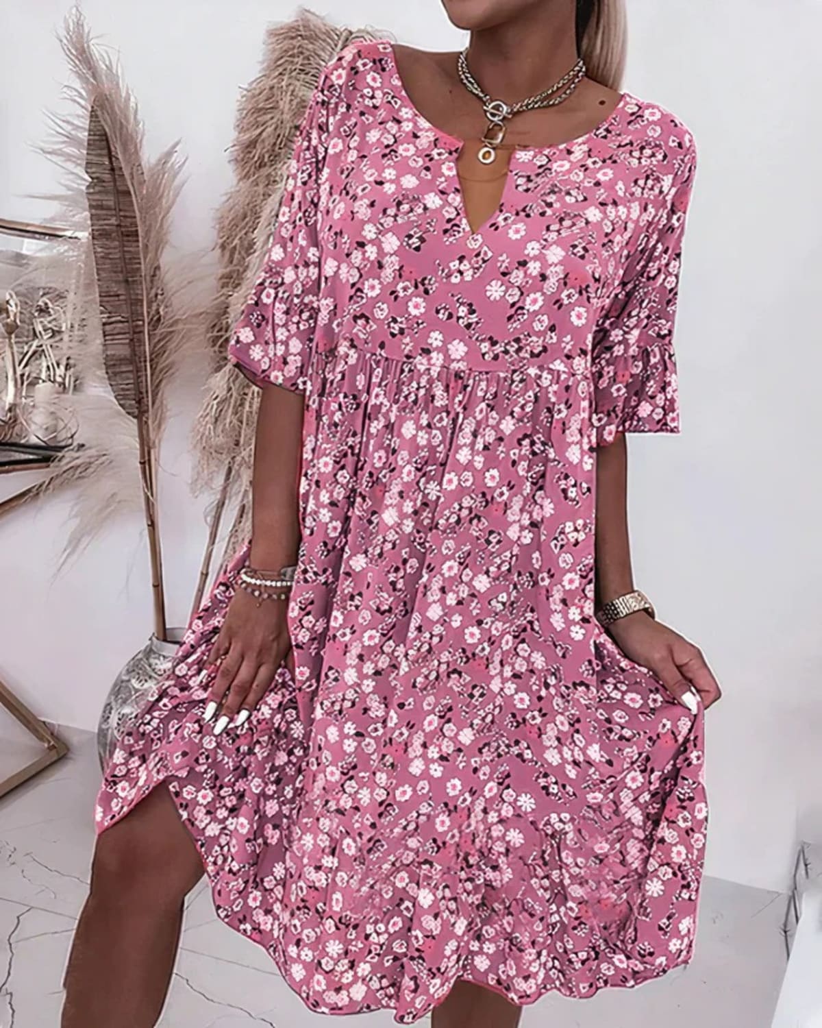 Woman wearing an elegant shift dress in a relaxed fit.