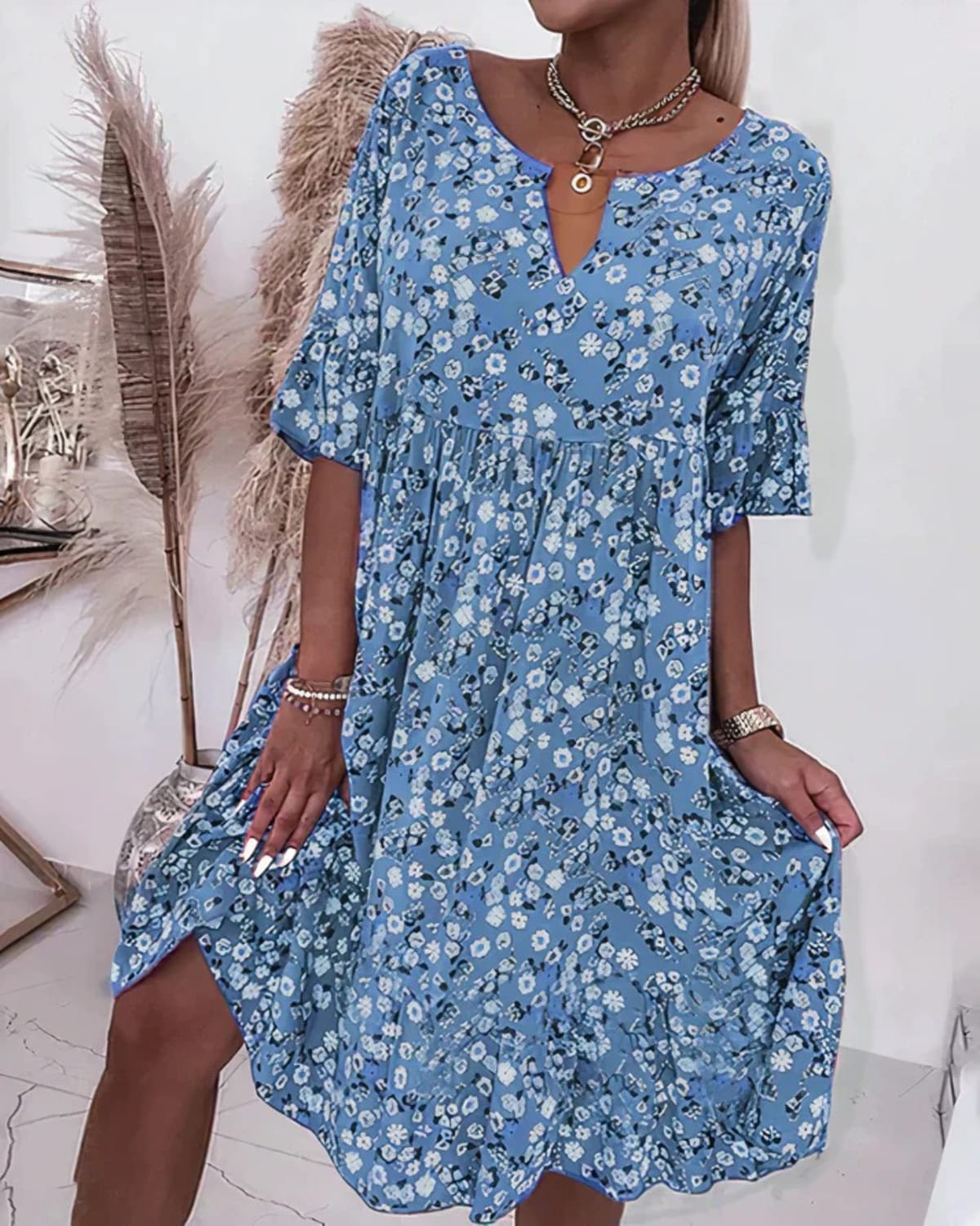 Woman wearing an elegant shift dress in a relaxed fit.