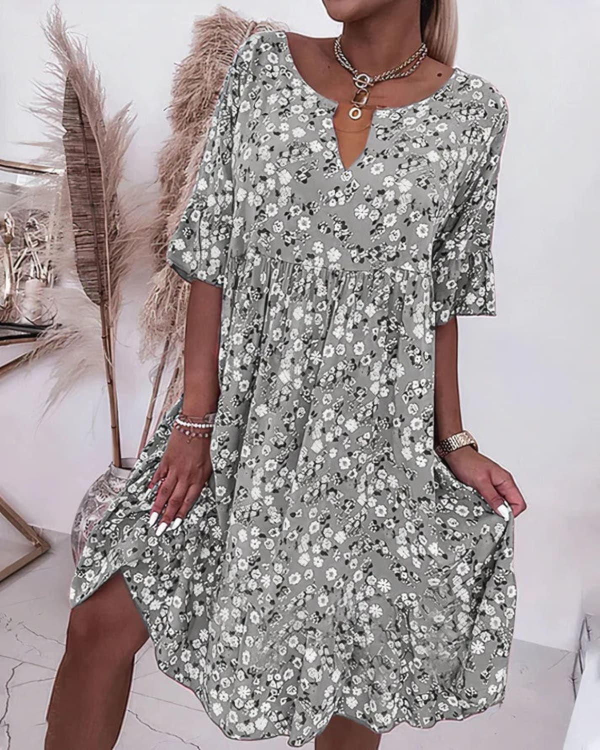 Woman wearing an elegant shift dress in a relaxed fit.