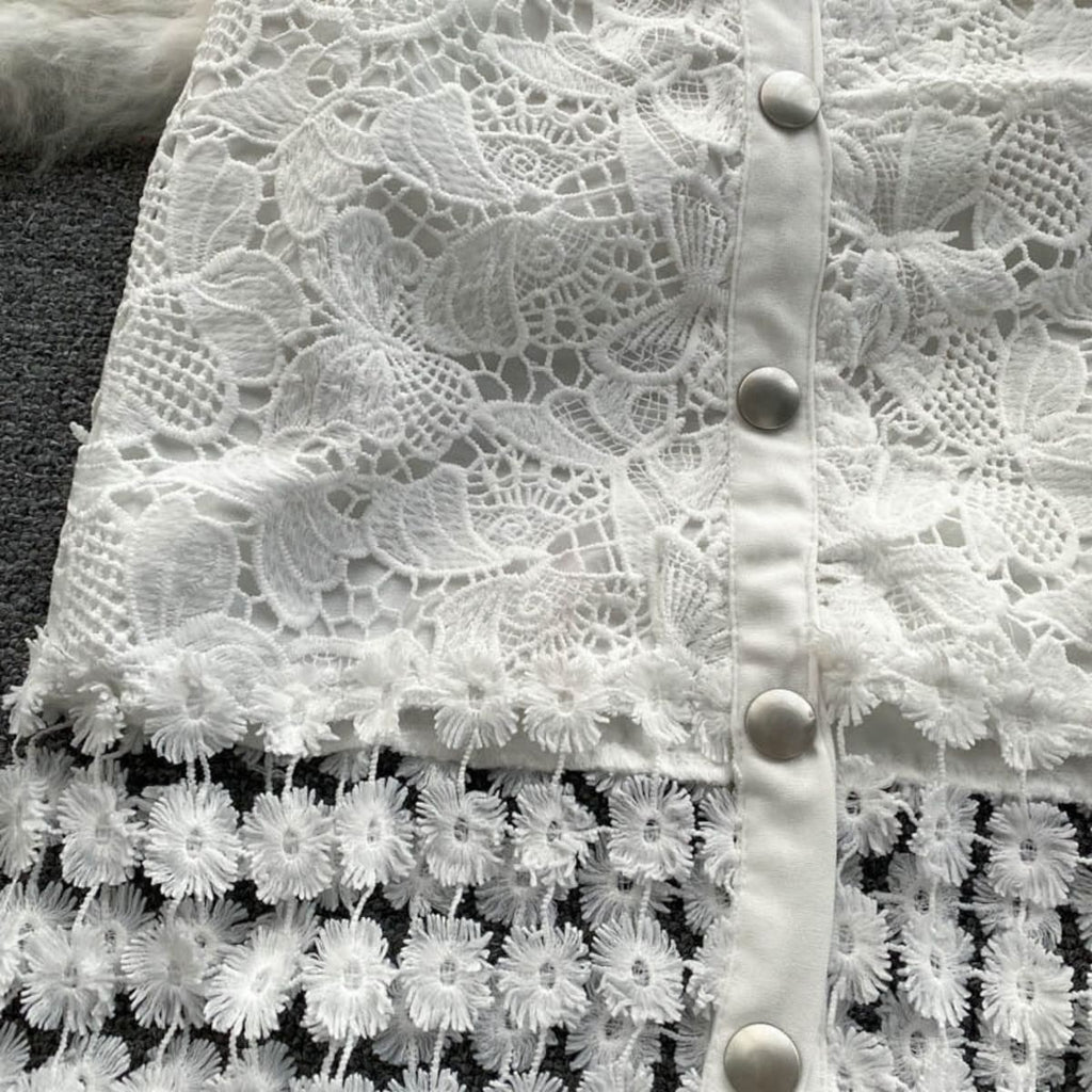 Sleeveless white lace midi dress with embellished skirt and button-down front.