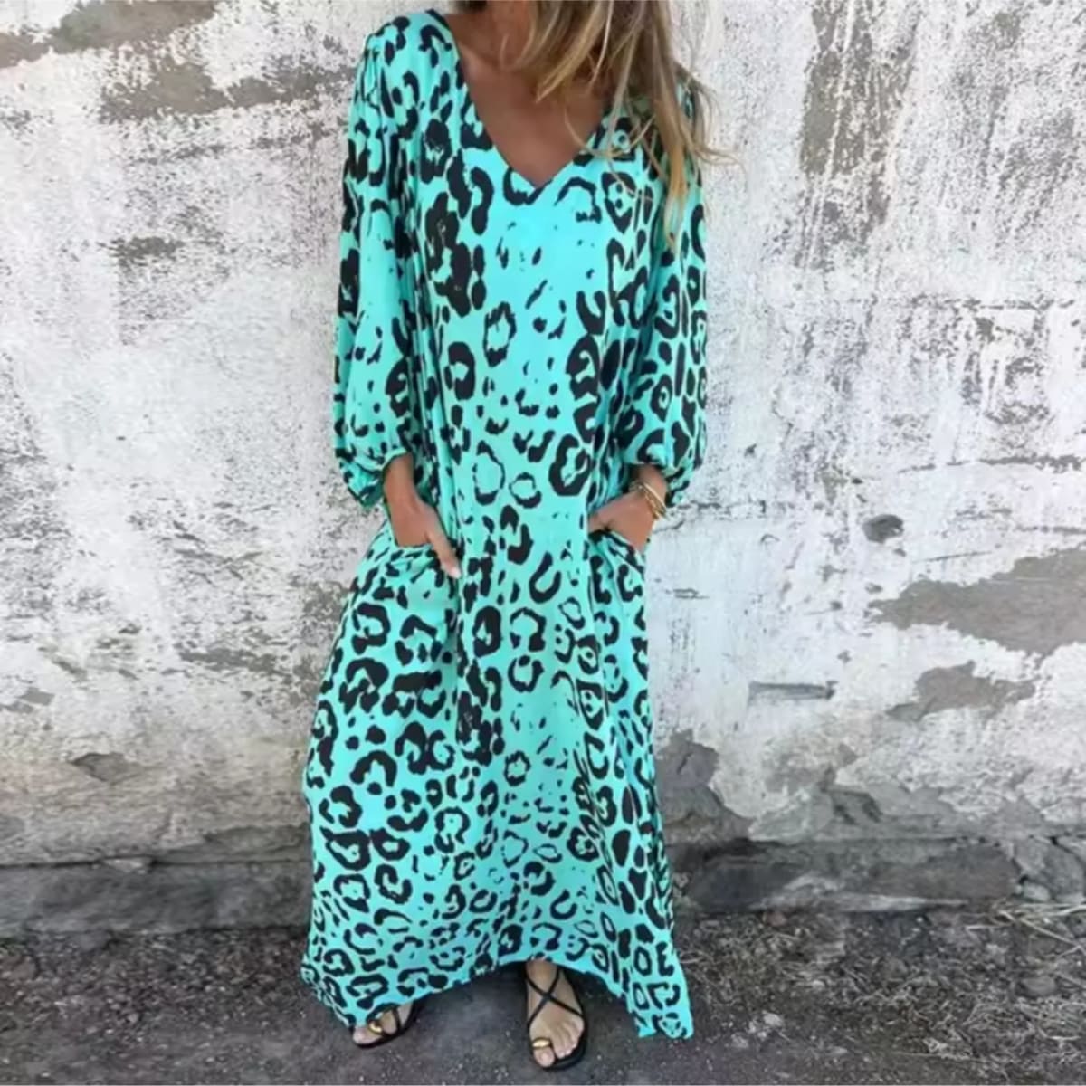 Flowing V-neck dress with long sleeves and bold patterns.