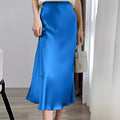 Woman wearing a high-waisted flowy midi slip skirt.