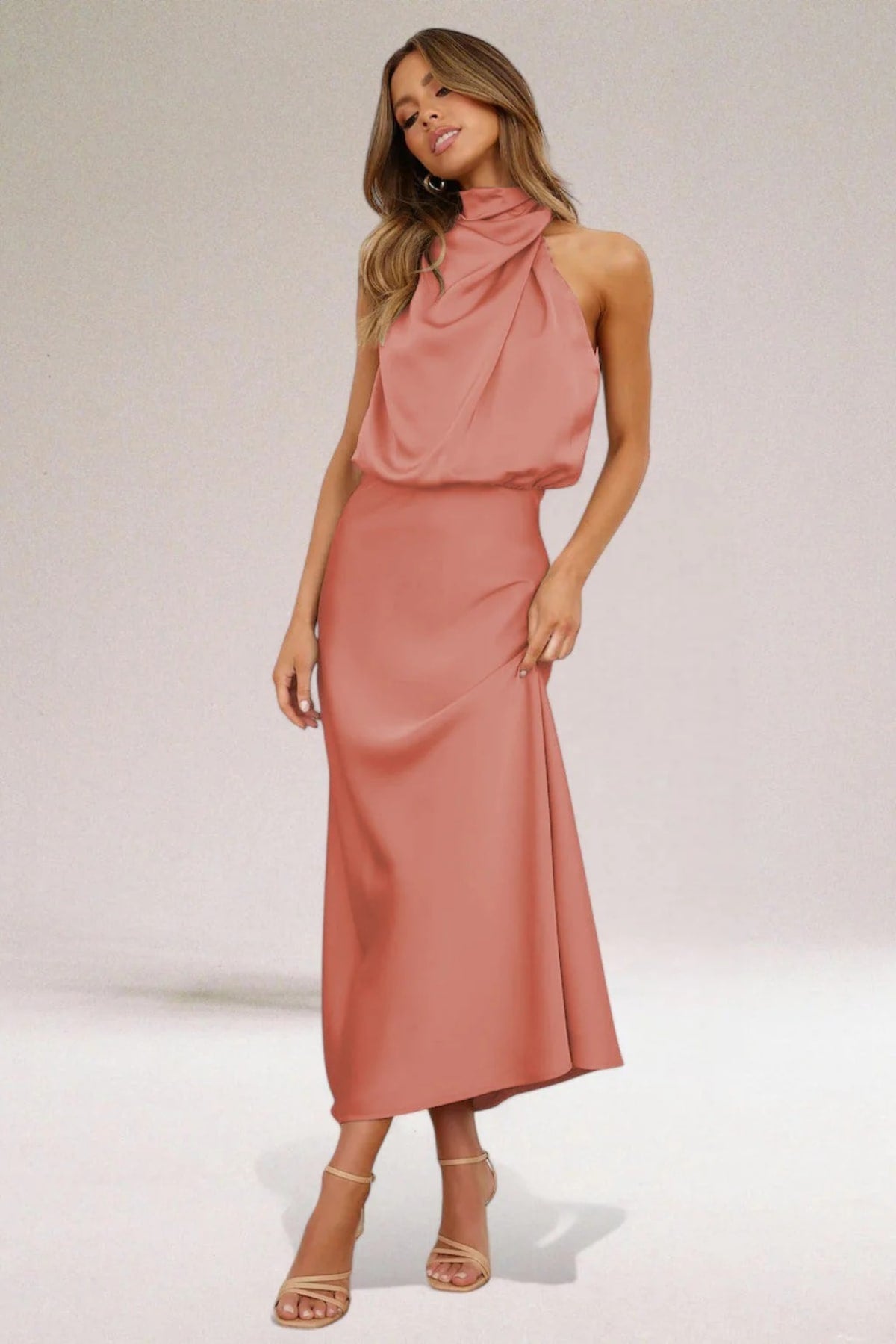 Halter neck evening dress with sleek silhouette and flowing fit.