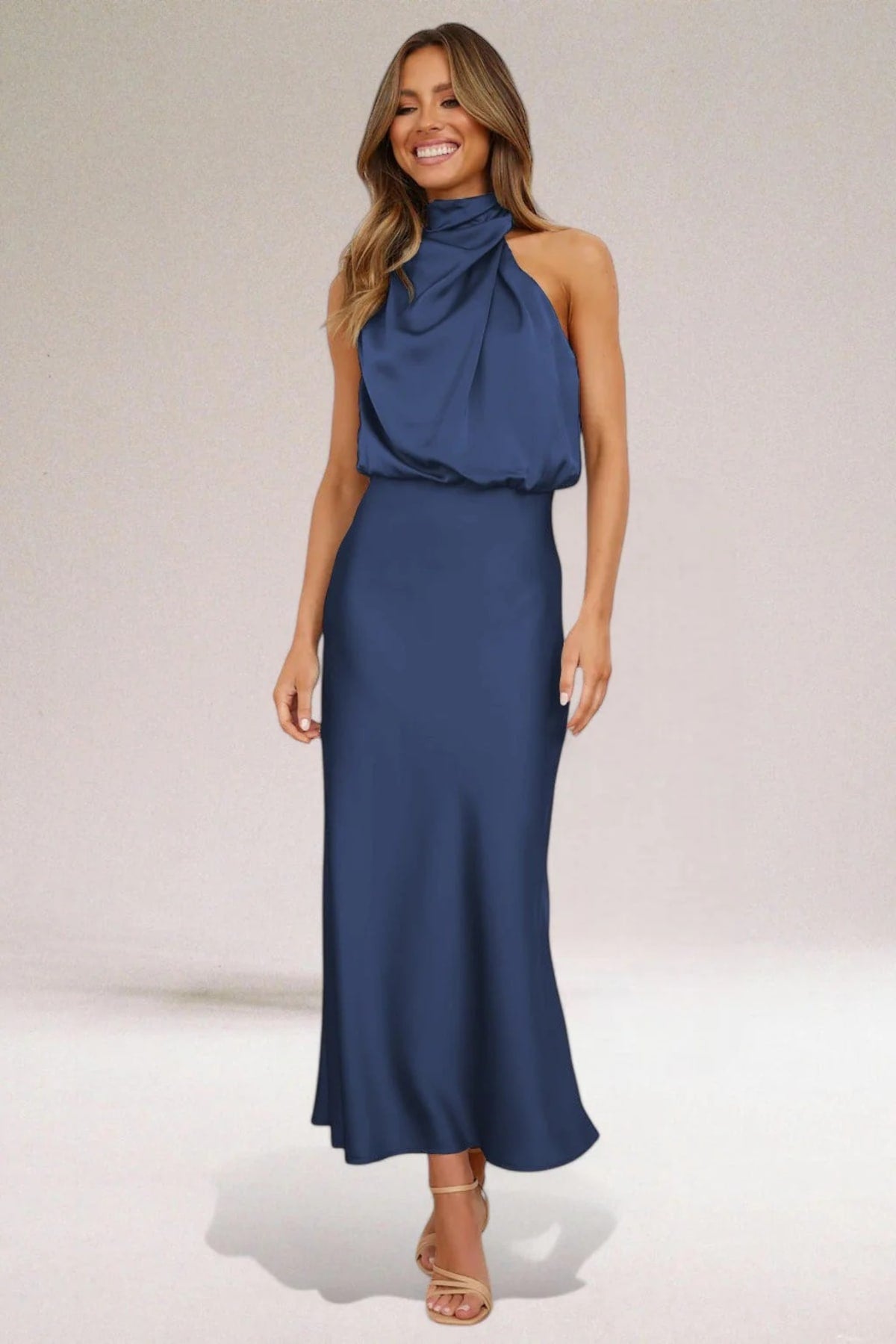 Halter neck evening dress with sleek silhouette and flowing fit.