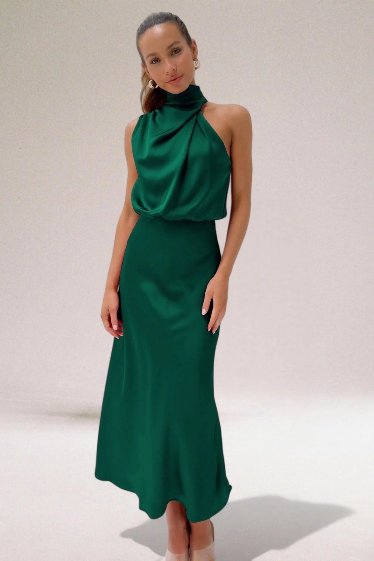 Halter neck evening dress with sleek silhouette and flowing fit.