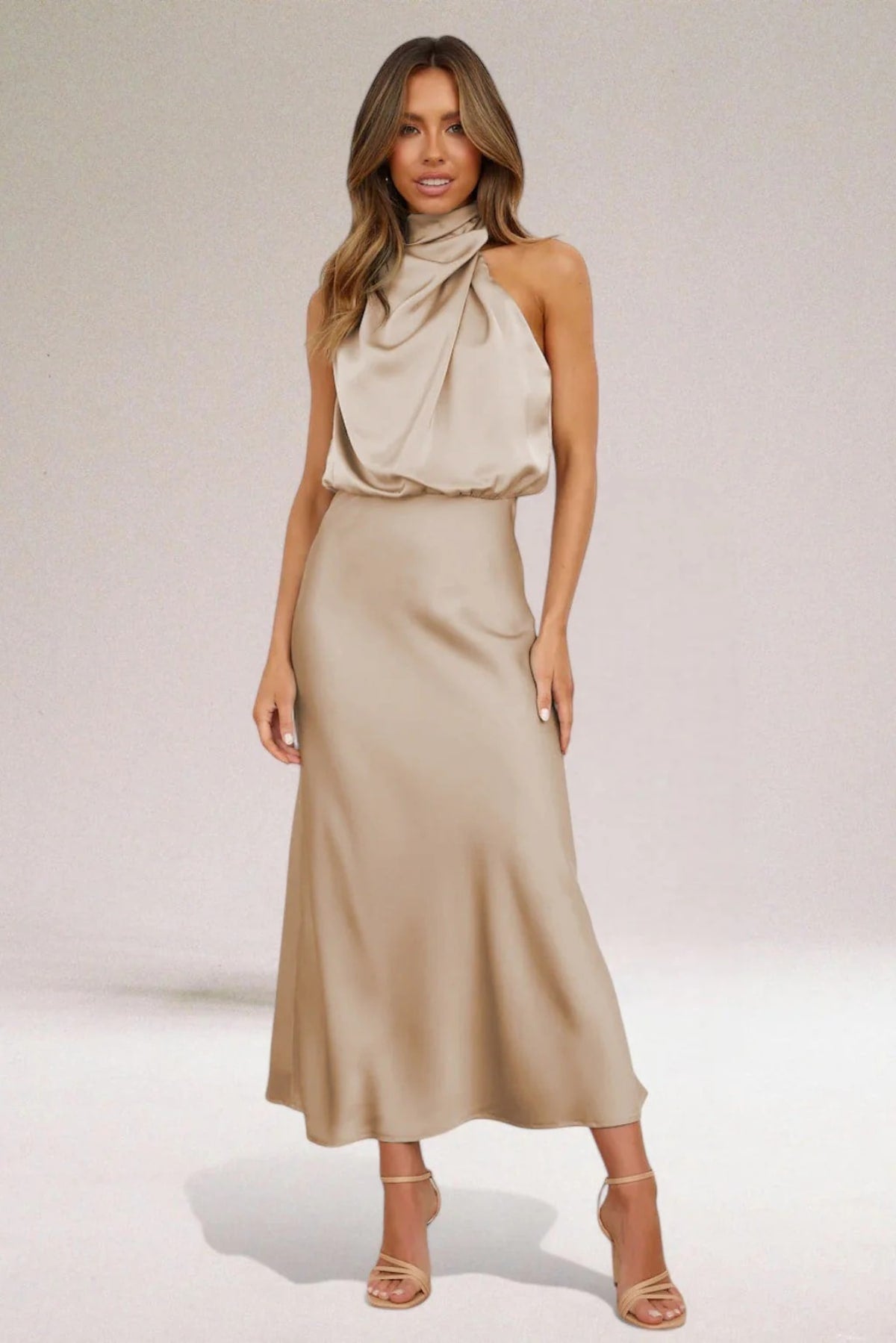 Halter neck evening dress with sleek silhouette and flowing fit.