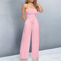Off-shoulder jumpsuit with wide legs and drawstring waist.