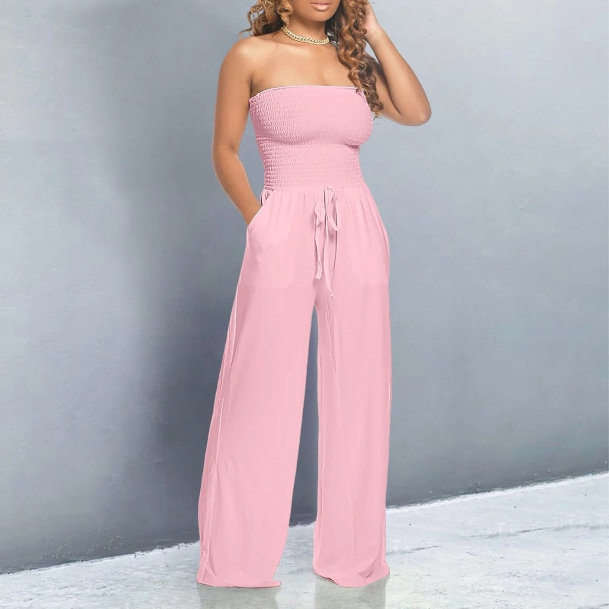 Off-shoulder jumpsuit with wide legs and drawstring waist.