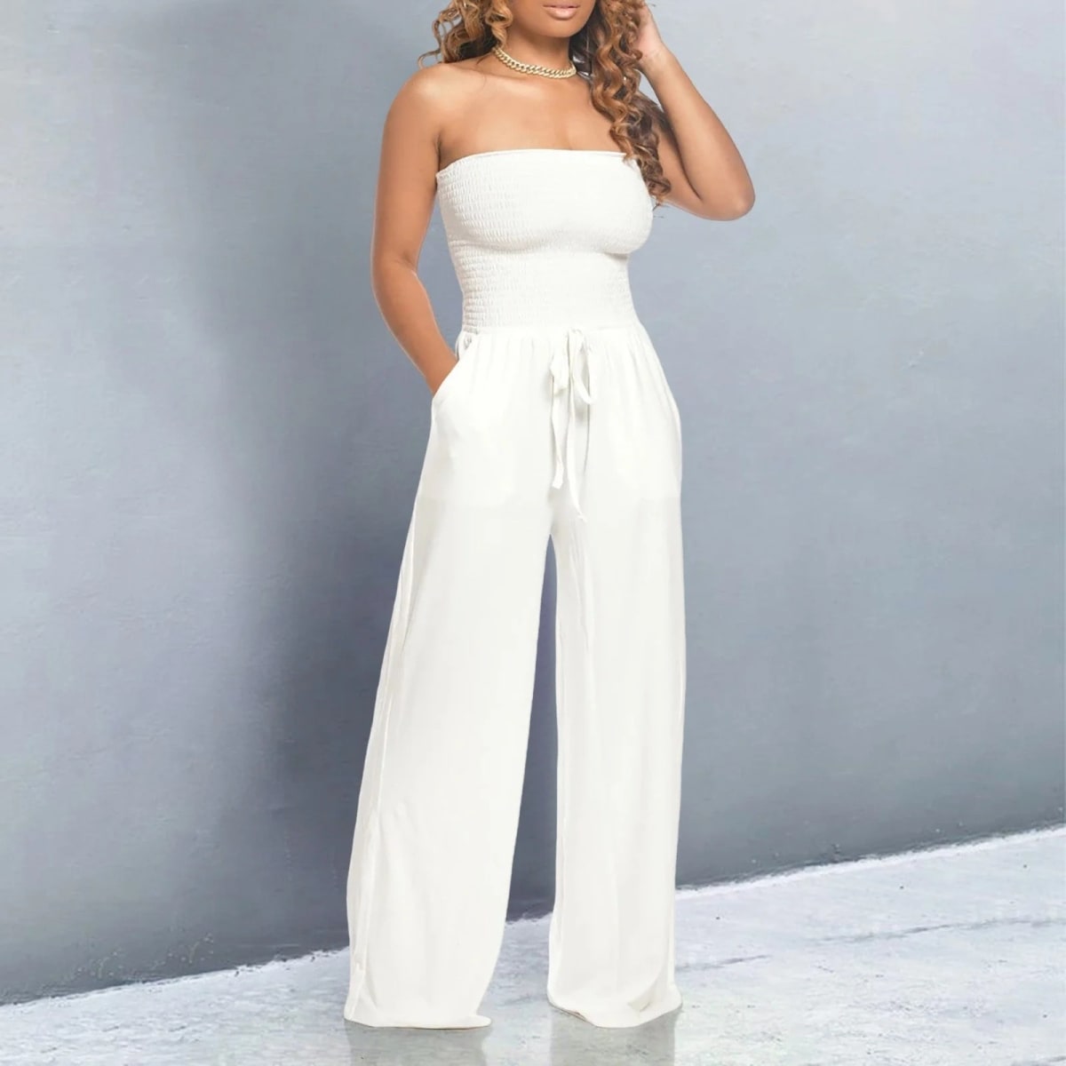Off-shoulder jumpsuit with wide legs and drawstring waist.