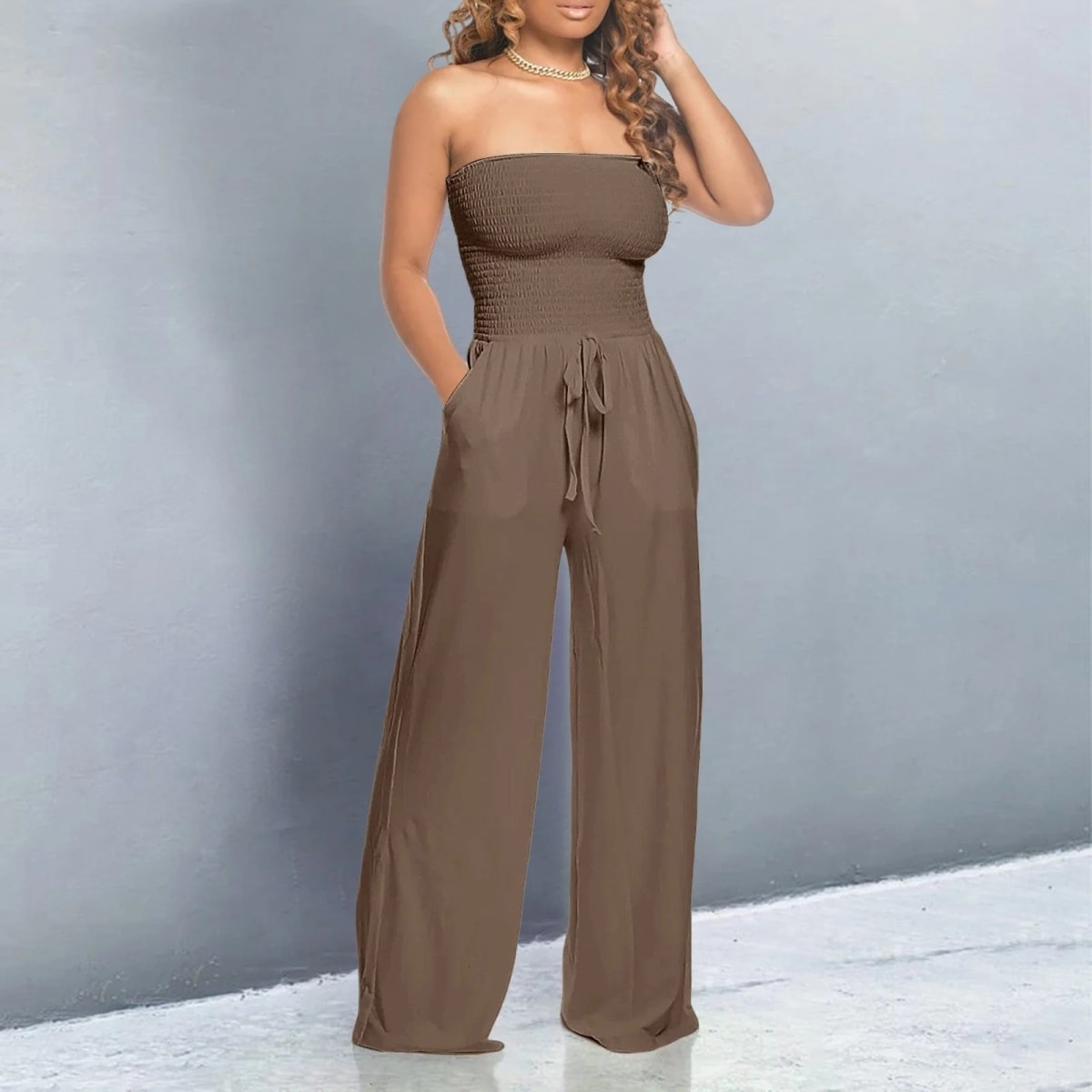 Off-shoulder jumpsuit with wide legs and drawstring waist.
