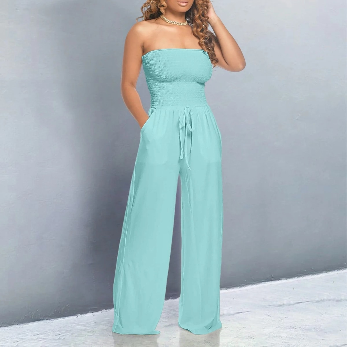 Off-shoulder jumpsuit with wide legs and drawstring waist.