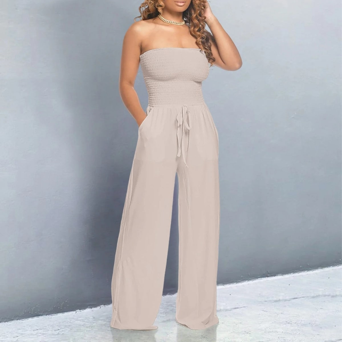 Off-shoulder jumpsuit with wide legs and drawstring waist.