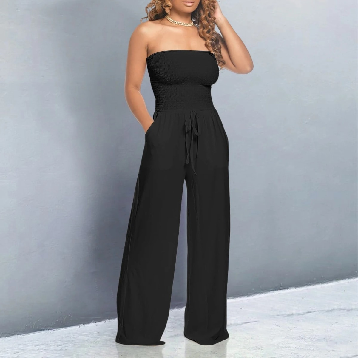 Off-shoulder jumpsuit with wide legs and drawstring waist.