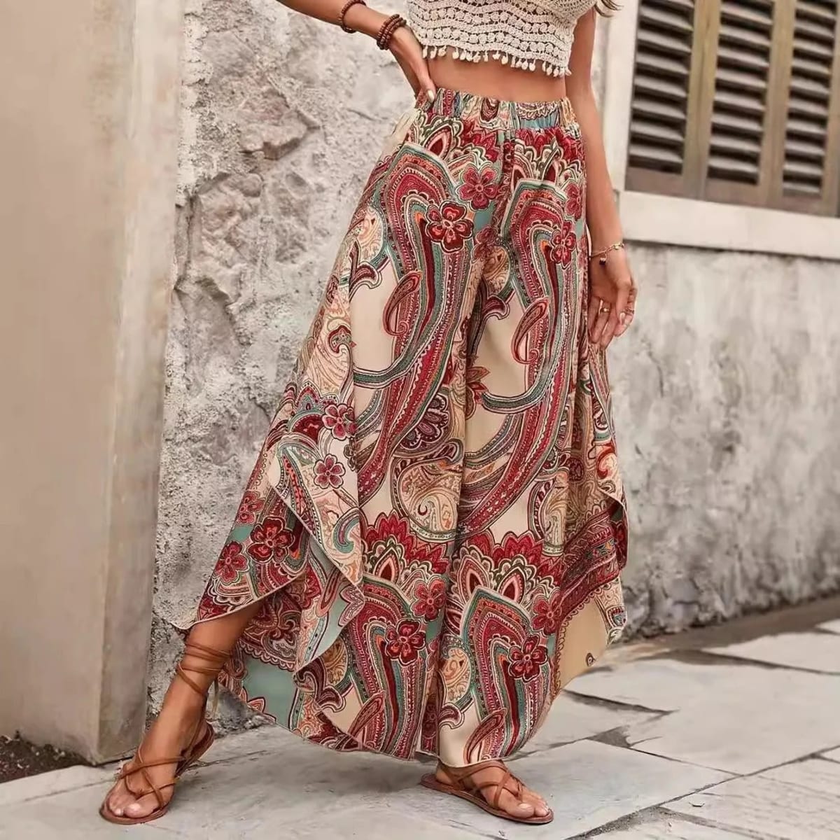 Model wearing paisley wide-leg palazzo pants with a white top.