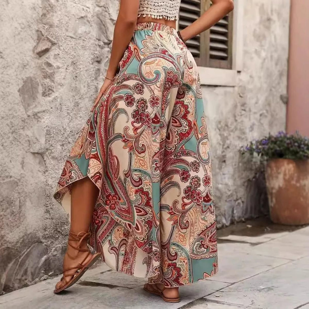 Model wearing paisley wide-leg palazzo pants with a white top.
