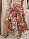 Model wearing paisley wide-leg palazzo pants with a white top.