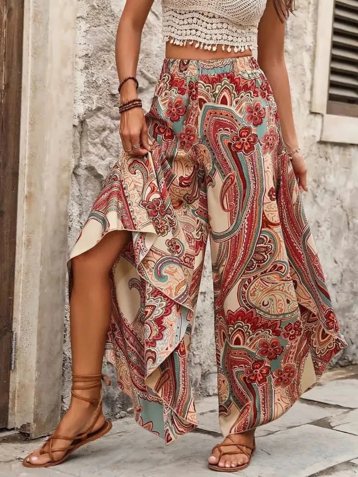 Model wearing paisley wide-leg palazzo pants with a white top.