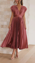 Woman wearing a pleated maxi dress with a V-neckline.