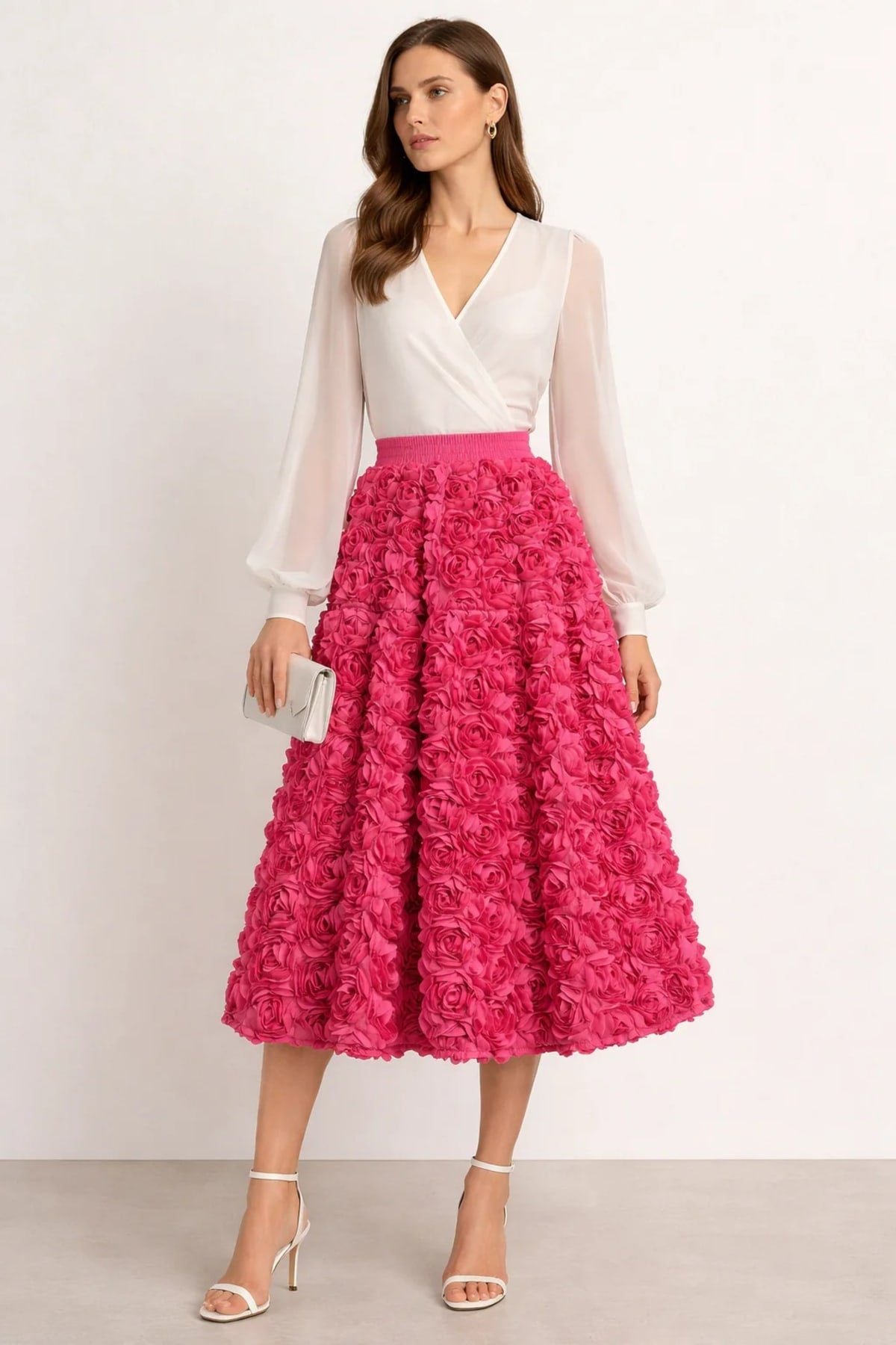 Woman wearing a midi skirt with rose appliques and a white blouse.