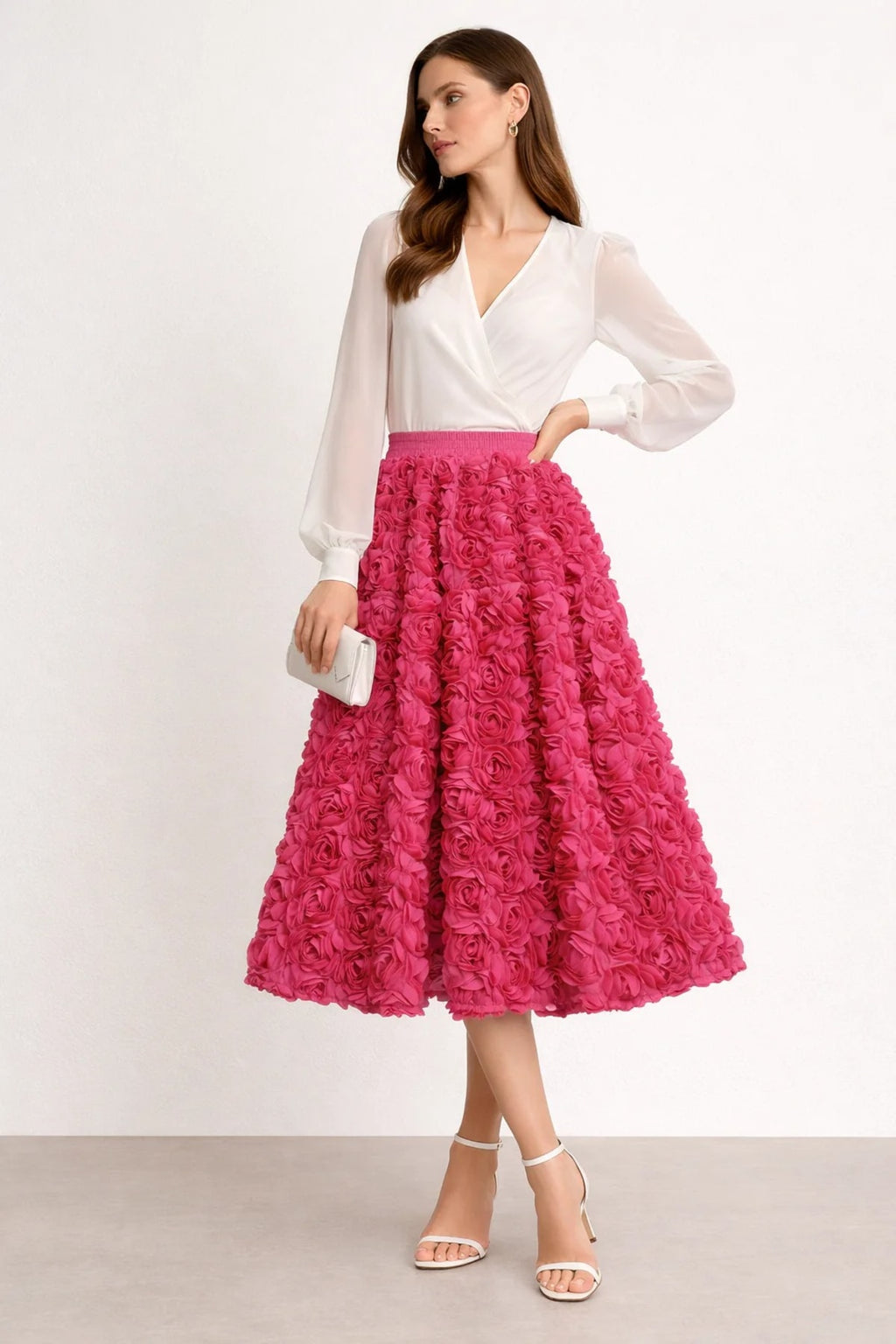 Woman wearing a midi skirt with rose appliques and a white blouse.