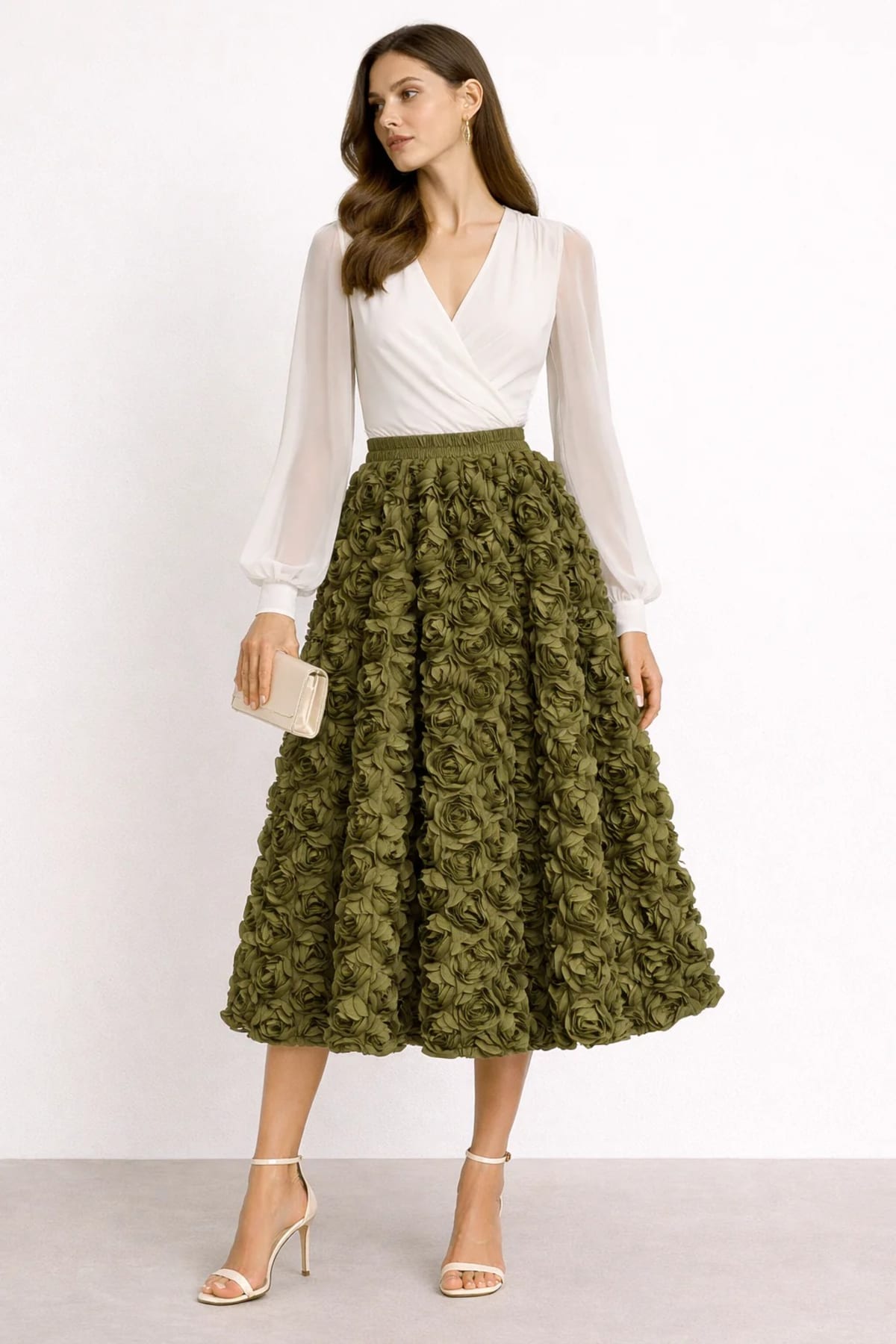 Woman wearing a midi skirt with rose appliques and a white blouse.
