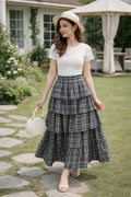 Woman wearing a plaid tiered maxi skirt outdoors
