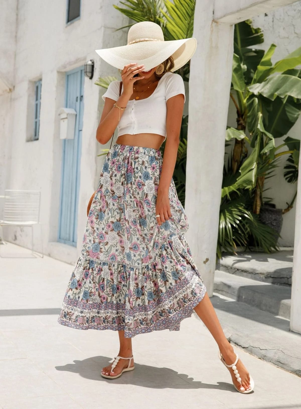Woman wearing floral tiered midi skirt with crop top.