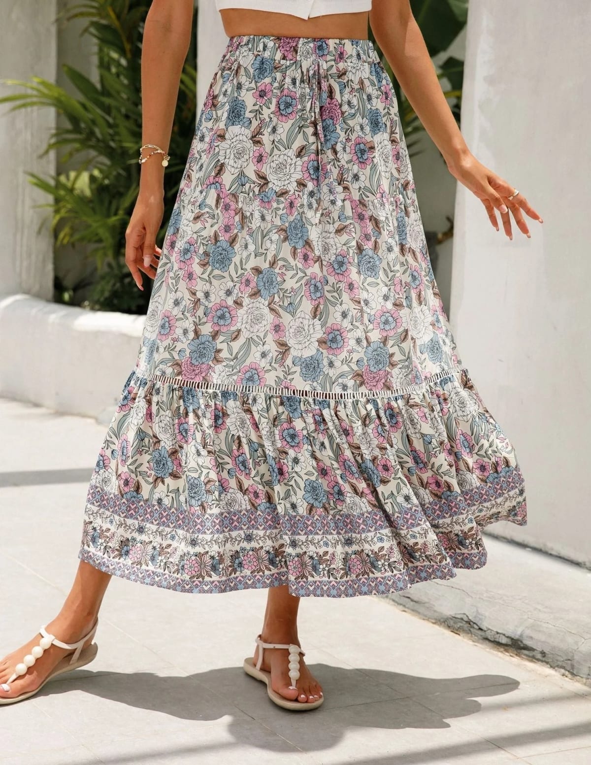 Woman wearing floral tiered midi skirt with crop top.