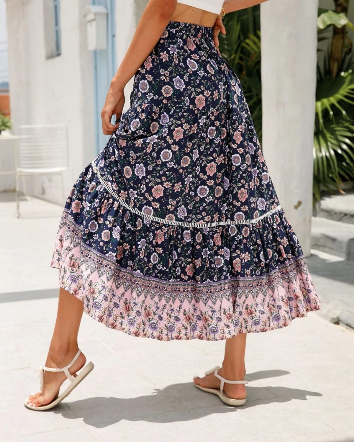 Woman wearing floral tiered midi skirt with crop top.
