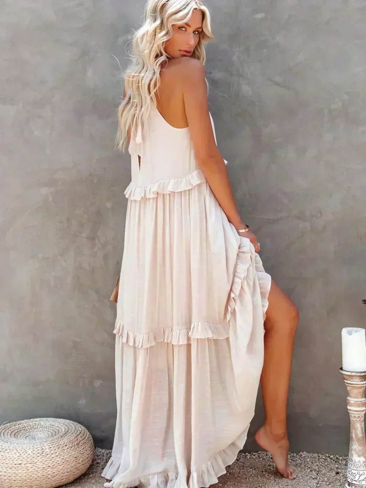 Sleeveless dress with ruffles, flowing fit, suitable for various occasions.