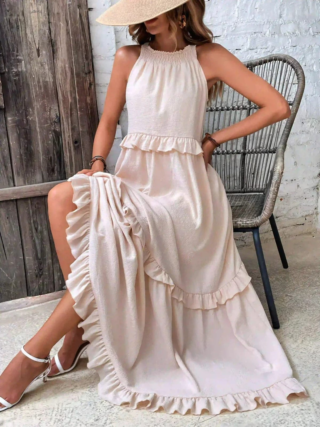 Sleeveless dress with ruffles, flowing fit, suitable for various occasions.