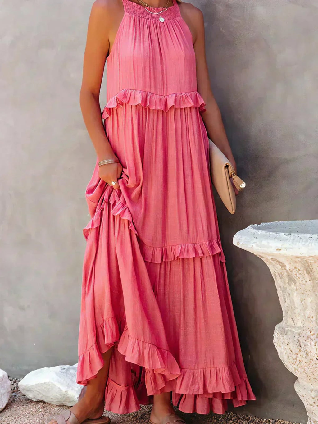 Sleeveless dress with ruffles, flowing fit, suitable for various occasions.