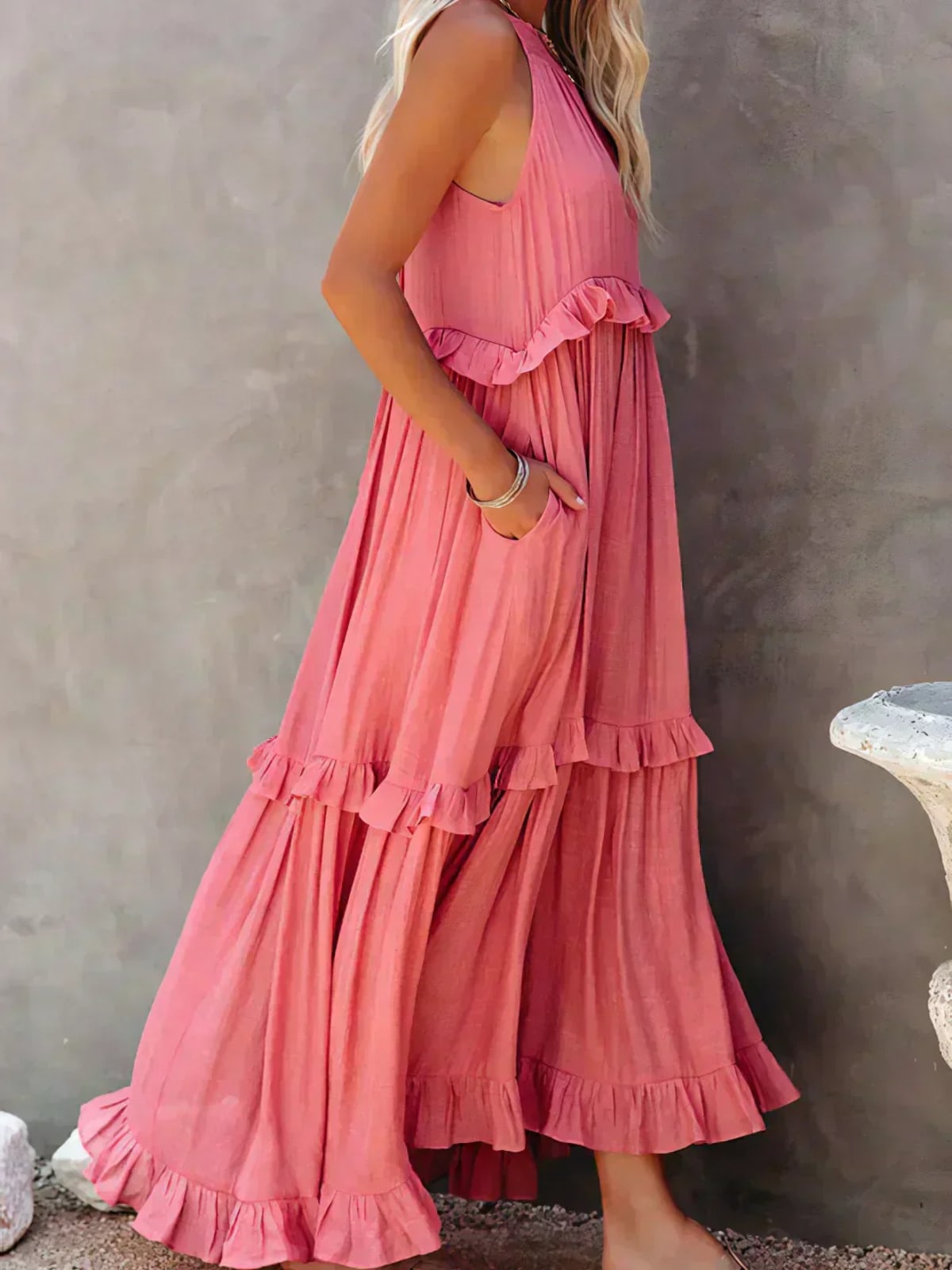 Sleeveless dress with ruffles, flowing fit, suitable for various occasions.