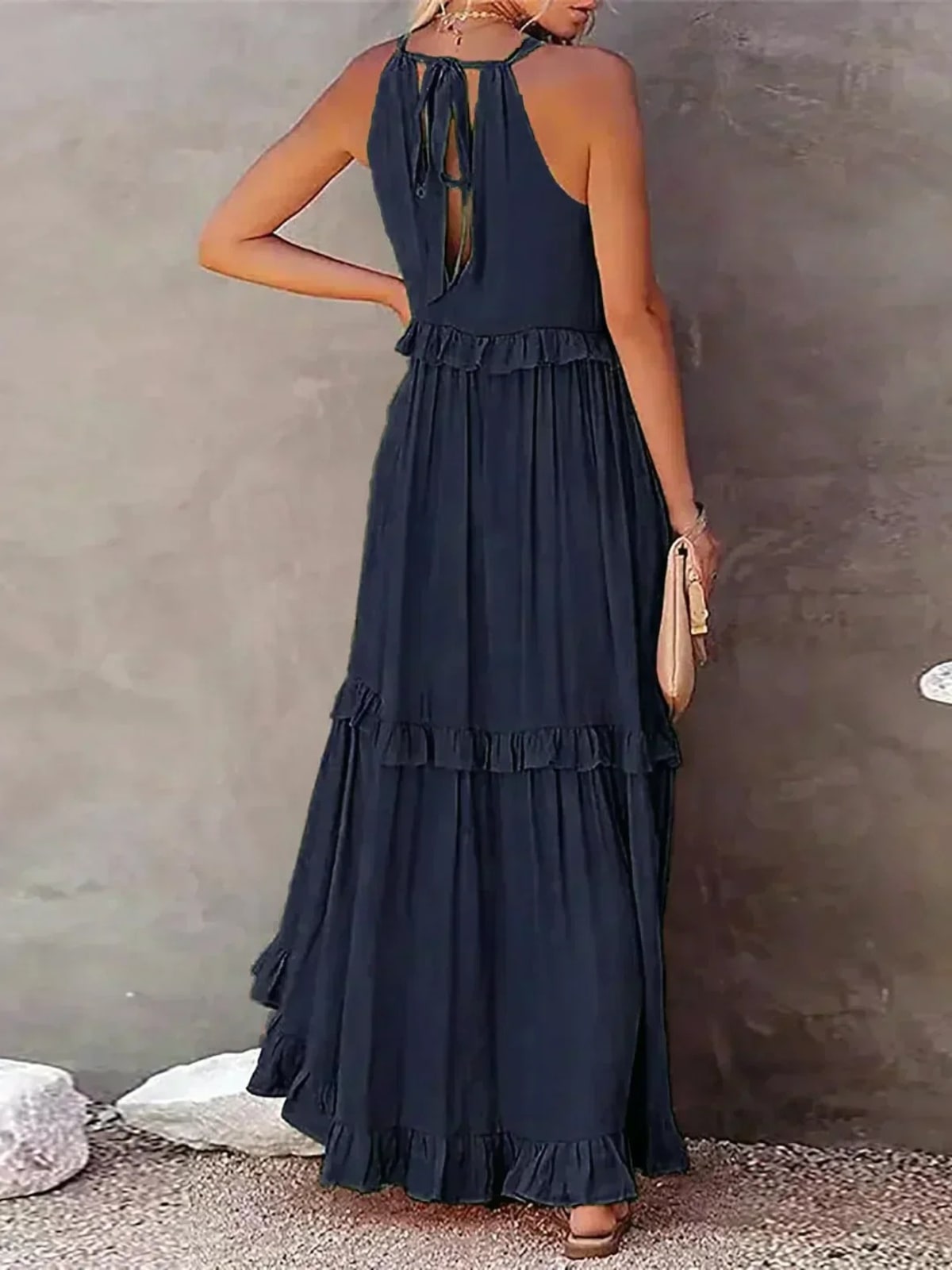 Sleeveless dress with ruffles, flowing fit, suitable for various occasions.