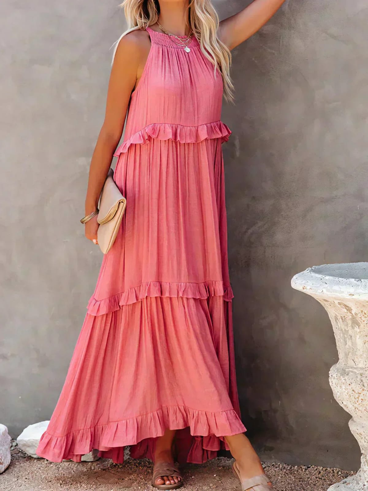 Sleeveless dress with ruffles, flowing fit, suitable for various occasions.