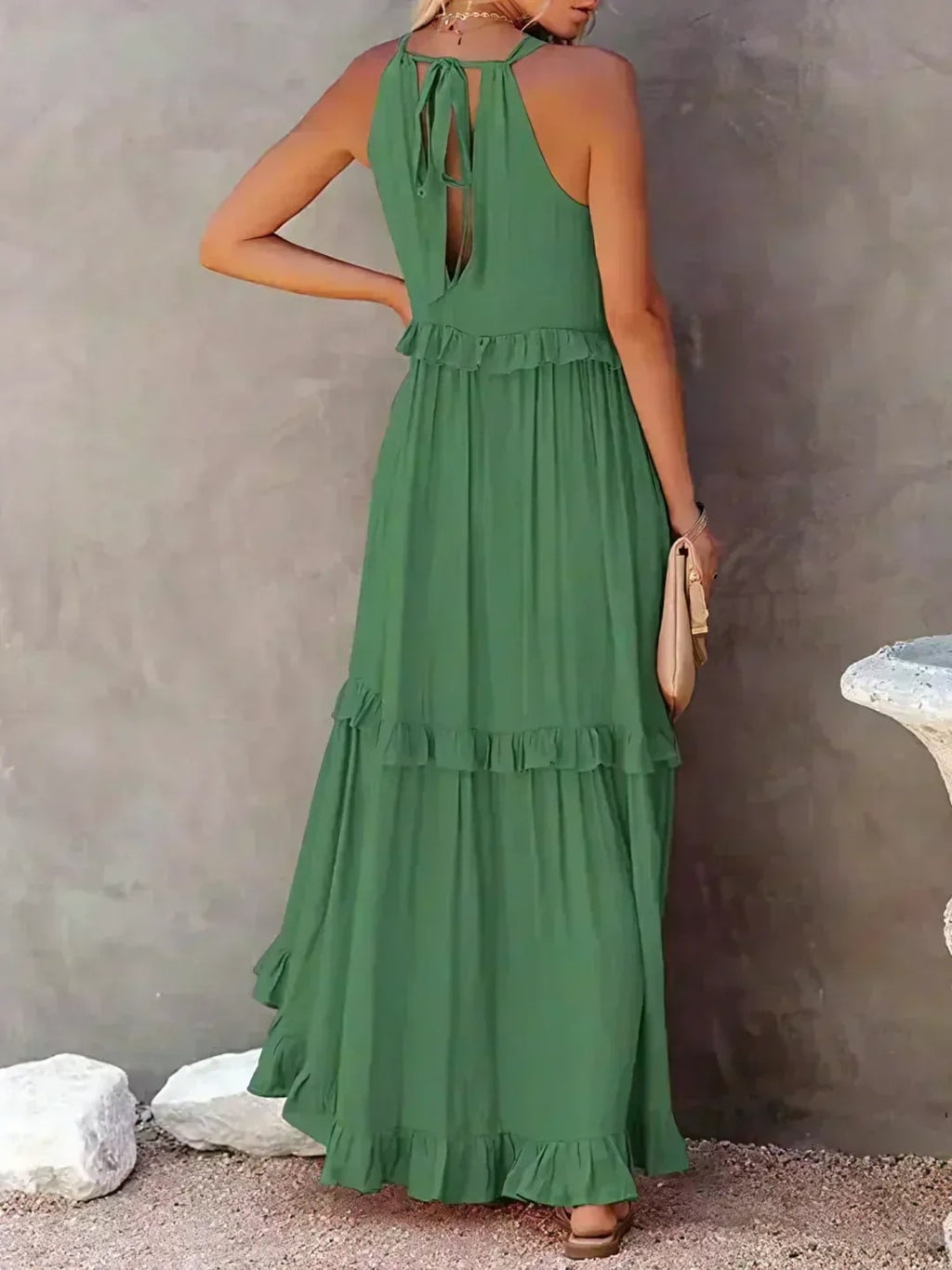 Sleeveless dress with ruffles, flowing fit, suitable for various occasions.