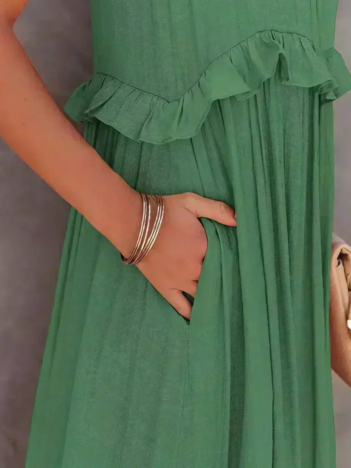 Sleeveless dress with ruffles, flowing fit, suitable for various occasions.