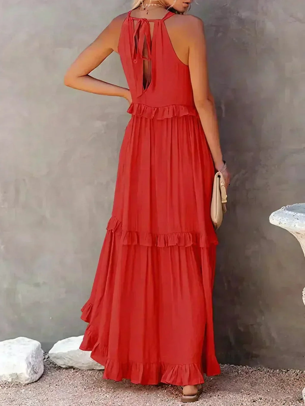 Sleeveless dress with ruffles, flowing fit, suitable for various occasions.