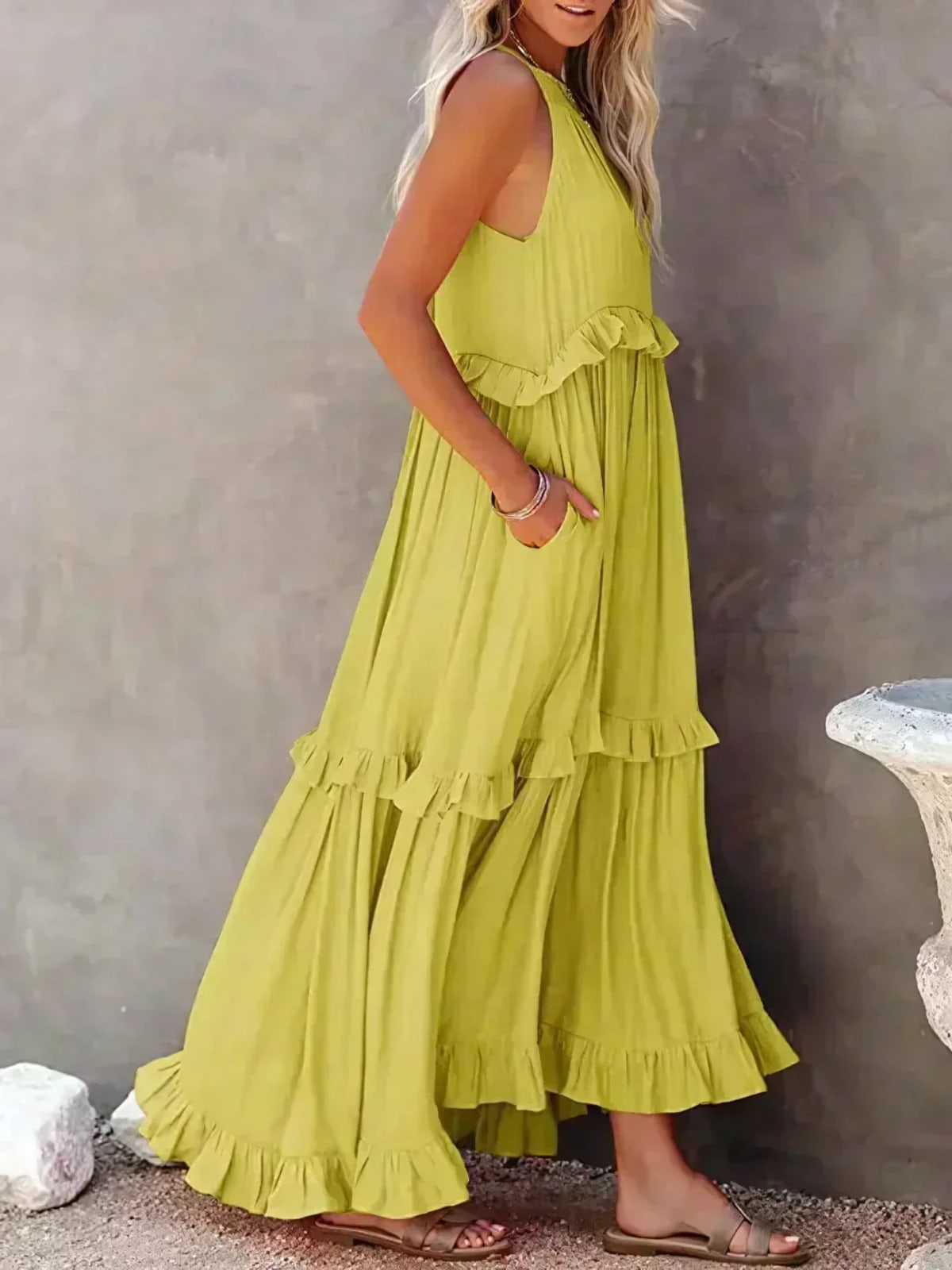 Sleeveless dress with ruffles, flowing fit, suitable for various occasions.