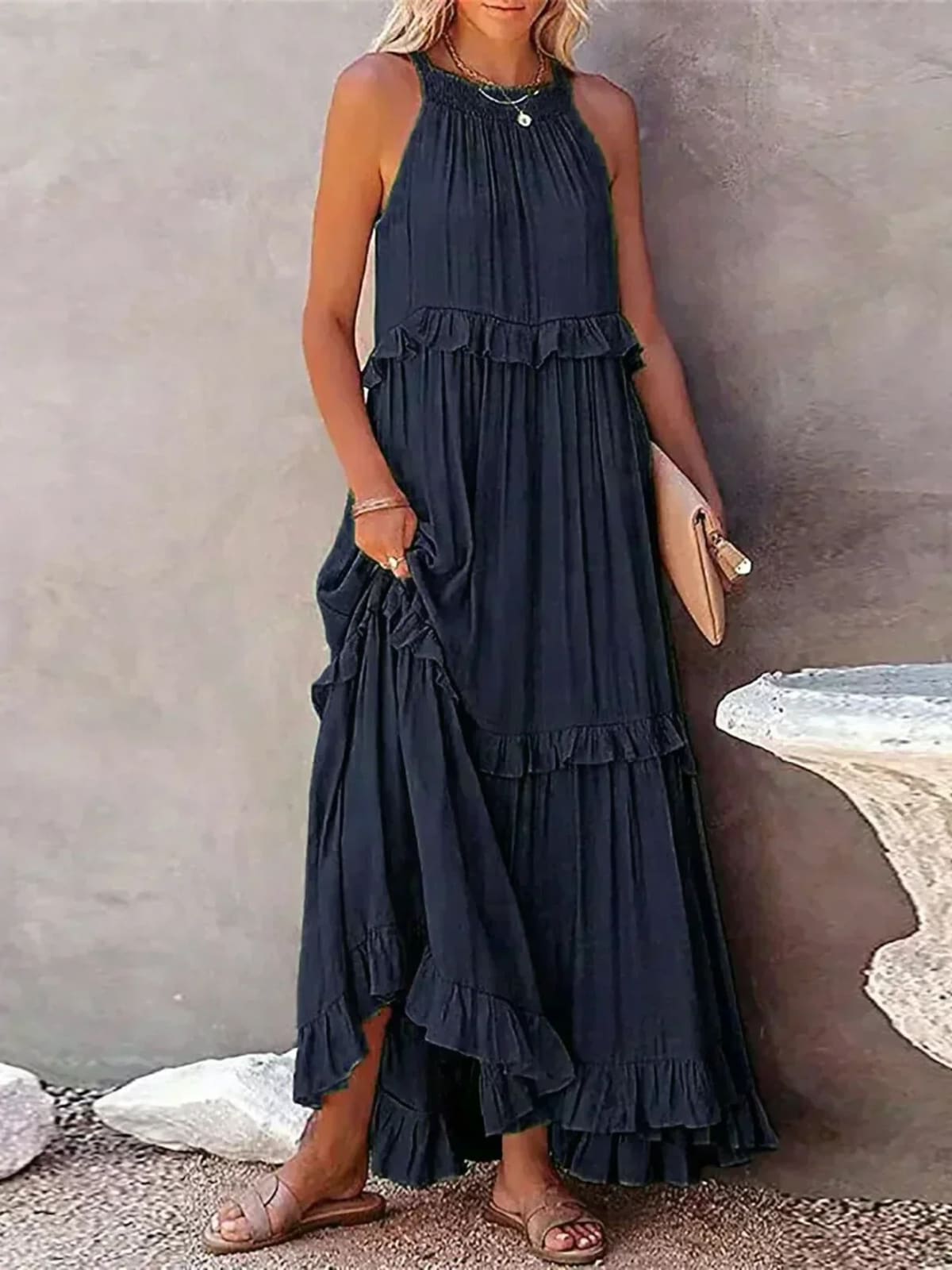 Sleeveless dress with ruffles, flowing fit, suitable for various occasions.