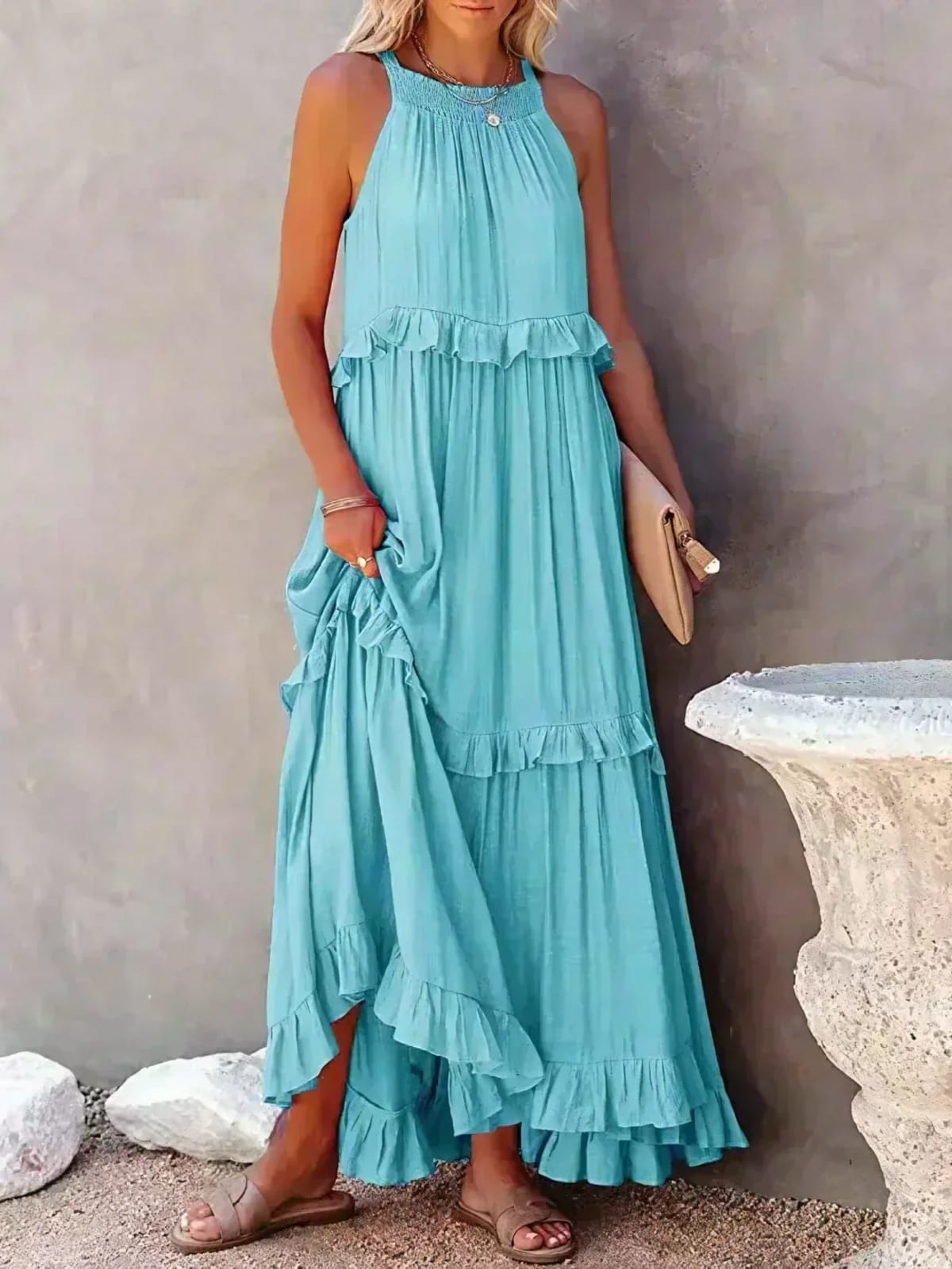 Sleeveless dress with ruffles, flowing fit, suitable for various occasions.